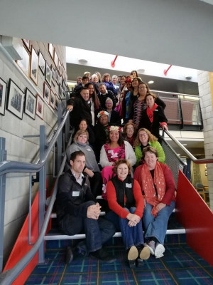 An image of a group of people sitting together on stairs